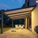 Patio with polycarbonate roofing and warm LED strip lighting installed on the beams of the roof