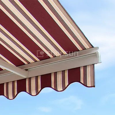 Front bar of the awning with hanging scalloped fabric in burgundy and beige stripes against a bright sky