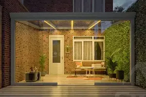 Entrance to the house enclosed with a glass roof and a sliding wall