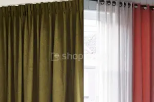 Window covered with a green curtain and a sheer drape, and a red curtain