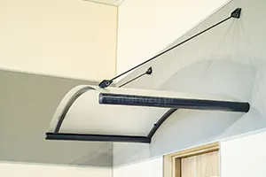 Rounded visors suspended on ties above the entrance door to the apartment